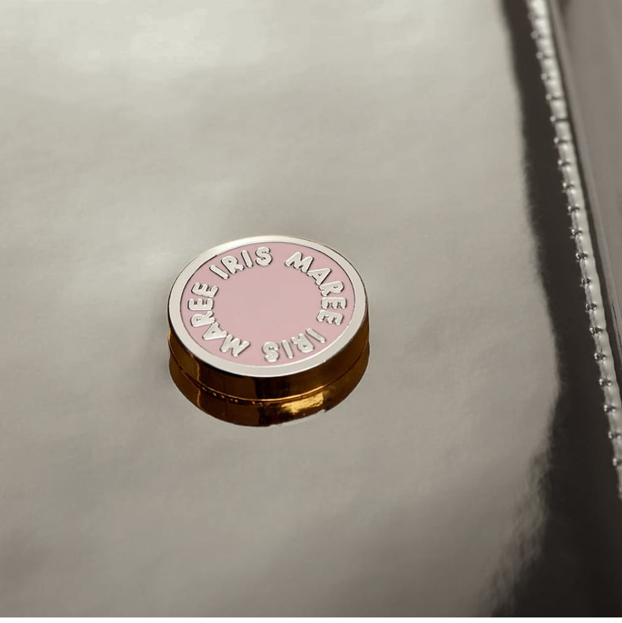 close up shot of Julian petite warm silver metallic pink and white Iris Maree logo on card case