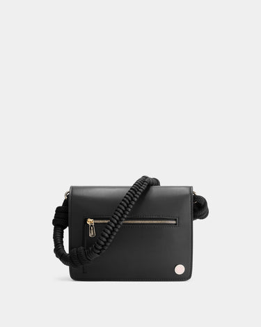 Luxury shoulder and crossbody bag in black, handcrafted from vegan leather and sustainable, cruelty-free Kayla Fabric™—an eco-friendly leather alternative. Designed by a Dutch designer, this authentic bag combines a sleek, rectangular shape with a knotted handle, offering versatility and style for any occasion. Soft gold detailing adds a luxurious touch, making it the best designer handbag for those seeking an ethical, high-quality accessory. Made in Europe.