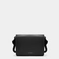 Luxury shoulder and crossbody bag in black, handcrafted from vegan leather and sustainable, cruelty-free Kayla Fabric™—an eco-friendly leather alternative. Designed by a Dutch designer, this authentic bag combines a sleek, rectangular shape with a knotted handle, offering versatility and style for any occasion. Soft gold detailing adds a luxurious touch, making it the best designer handbag for those seeking an ethical, high-quality accessory. Made in Europe.