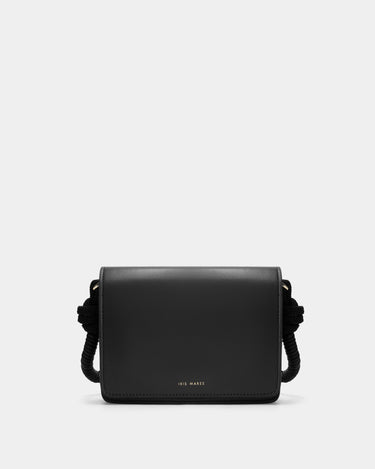 Luxury shoulder and crossbody bag in black, handcrafted from vegan leather and sustainable, cruelty-free Kayla Fabric™—an eco-friendly leather alternative. Designed by a Dutch designer, this authentic bag combines a sleek, rectangular shape with a knotted handle, offering versatility and style for any occasion. Soft gold detailing adds a luxurious touch, making it the best designer handbag for those seeking an ethical, high-quality accessory. Made in Europe.