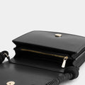 Luxury shoulder and crossbody bag in black, handcrafted from vegan leather and sustainable, cruelty-free Kayla Fabric™—an eco-friendly leather alternative. Designed by a Dutch designer, this authentic bag combines a sleek, rectangular shape with a knotted handle, offering versatility and style for any occasion. Soft gold detailing adds a luxurious touch, making it the best designer handbag for those seeking an ethical, high-quality accessory. Made in Europe.