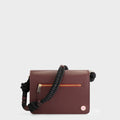 Luxury shoulder and crossbody bag in burgundy, handcrafted from vegan leather and sustainable, cruelty-free Kayla Fabric™—an eco-friendly leather alternative. Designed by a Dutch designer, this authentic bag combines a sleek, rectangular shape with a knotted handle, offering versatility and style for any occasion. Soft gold detailing adds a luxurious touch, making it the best designer handbag for those seeking an ethical, high-quality accessory. Made in Europe.