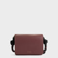 Luxury shoulder and crossbody bag in burgundy, handcrafted from vegan leather and sustainable, cruelty-free Kayla Fabric™—an eco-friendly leather alternative. Designed by a Dutch designer, this authentic bag combines a sleek, rectangular shape with a knotted handle, offering versatility and style for any occasion. Soft gold detailing adds a luxurious touch, making it the best designer handbag for those seeking an ethical, high-quality accessory. Made in Europe.