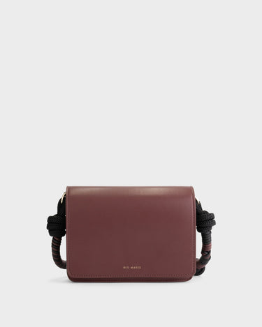 Luxury shoulder and crossbody bag in burgundy, handcrafted from vegan leather and sustainable, cruelty-free Kayla Fabric™—an eco-friendly leather alternative. Designed by a Dutch designer, this authentic bag combines a sleek, rectangular shape with a knotted handle, offering versatility and style for any occasion. Soft gold detailing adds a luxurious touch, making it the best designer handbag for those seeking an ethical, high-quality accessory. Made in Europe.
