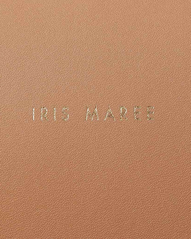 Close up shot of gold Iris Maree logo on Sandy Brown Kayla Fabric