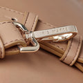 Close up of gold clip on strap with iris Maree logo engraved on clip