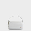 Luxury handbag and crossbody bag in white with a unique cylindrical silhouette, handmade from vegan, sustainable, and cruelty-free Kayla Fabric™—an eco-friendly leather alternative. Designed by a Dutch designer, this authentic bag is lightweight, featuring a magnetic flap and soft gold hardware for a touch of elegance. The best designer handbag for those seeking ethical style and versatility in an everyday accessory. Made in Europe.