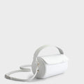 Luxury handbag and crossbody bag in white with a unique cylindrical silhouette, handmade from vegan, sustainable, and cruelty-free Kayla Fabric™—an eco-friendly leather alternative. Designed by a Dutch designer, this authentic bag is lightweight, featuring a magnetic flap and soft gold hardware for a touch of elegance. The best designer handbag for those seeking ethical style and versatility in an everyday accessory. Made in Europe.