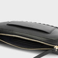 Luxury mini shoulder bag in black, handcrafted in collaboration with AVDW Antwerp from vegan, sustainable, and cruelty-free Kayla Fabric™—an eco-friendly leather alternative. Designed by a Dutch designer, this authentic bag features a compact, curved design with hand-knotted cords and soft gold accents, blending artistry with practicality. The best designer handbag for those seeking ethical elegance. Made in Europe.