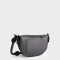 Luxury mini shoulder bag in black, handcrafted in collaboration with AVDW Antwerp from vegan, sustainable, and cruelty-free Kayla Fabric™—an eco-friendly leather alternative. Designed by a Dutch designer, this authentic bag features a compact, curved design with hand-knotted cords and soft gold accents, blending artistry with practicality. The best designer handbag for those seeking ethical elegance. Made in Europe.