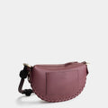 Luxury mini shoulder bag in burgundy, handcrafted in collaboration with AVDW Antwerp from vegan, sustainable, and cruelty-free Kayla Fabric™—an eco-friendly leather alternative. Designed by a Dutch designer, this authentic bag features a compact, curved design with hand-knotted cords and soft gold accents, blending artistry with practicality. The best designer handbag for those seeking ethical elegance. Made in Europe.