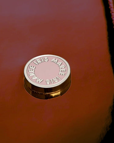  Pink and Gold logo accessory close up shot on metallic Kayla Fabric