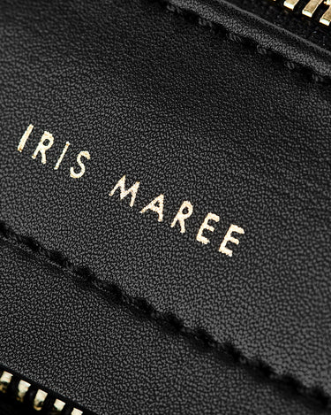 Close up shot of gold Iris Maree logo on Midnight Black bag on Kayla Fabric