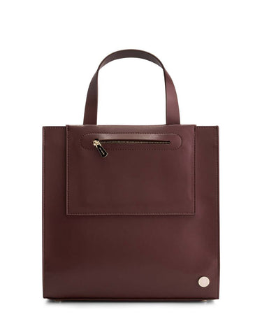 Jude Mini Tote in Lily Maroon Burgundy with top-handle the back of the bag has a pink and white Iris Maree logo on the bottom of the bag and on the top area of the bag there is one gold zip pocket with a gold zipper made from environmentally conscious material Kayla Fabric