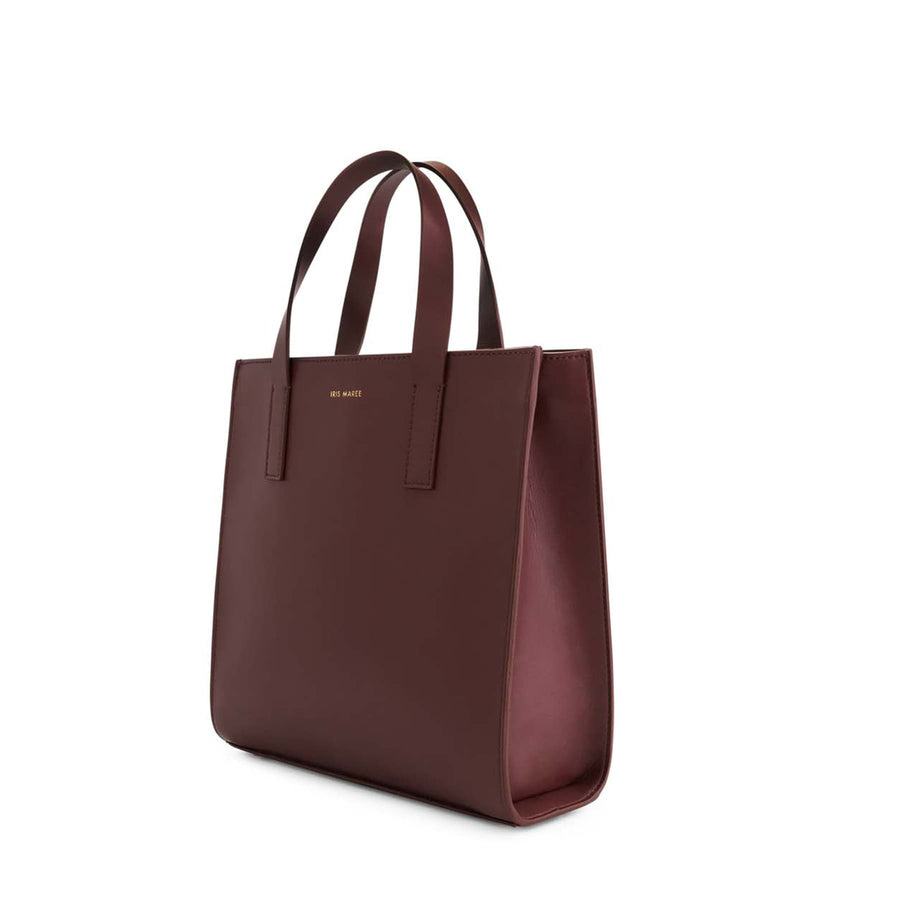 Jude Mini Tote Bag in Lily Maroon Burgundy with top-handle and a gold Iris Maree logo on the front of the bag made from environmentally conscious material Kayla Fabric