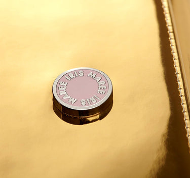 Julian Petit Golden Light Metallic close up shot of the Iris Maree pink and white logo on bag